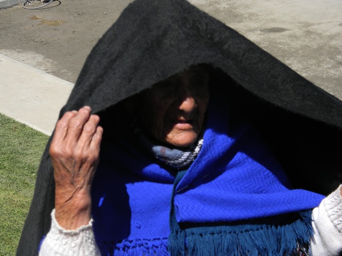 A local grandmother protecting herself from the intense sun.