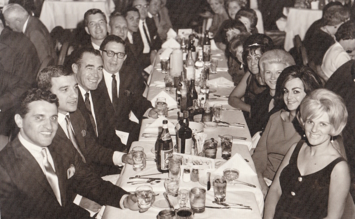 My parents in Vegas with the "I"s (couple seated in the foreground) during the 1960s. My mother, though difficult to see, is seated across from my father (5th fellow on left).