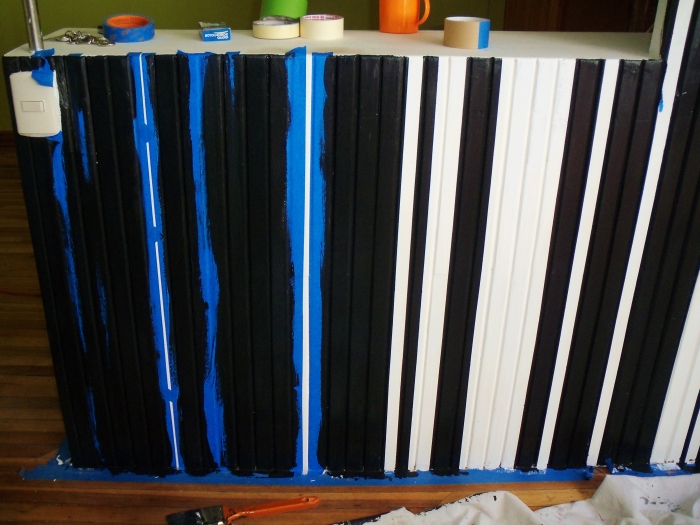Taping to create stripes on one studio wall--